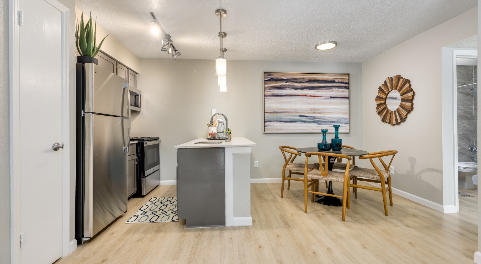a kitchen and dining area with hardwood floors at The Winslow