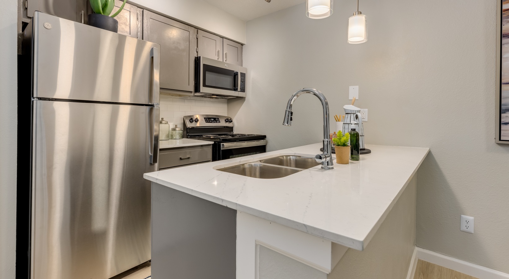 kitchen with stainless steel appliances and granite countertops at The Winslow